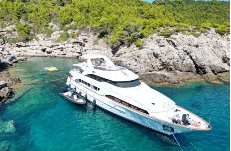 M/Y Friendship anchored in a rocky Balearic cala