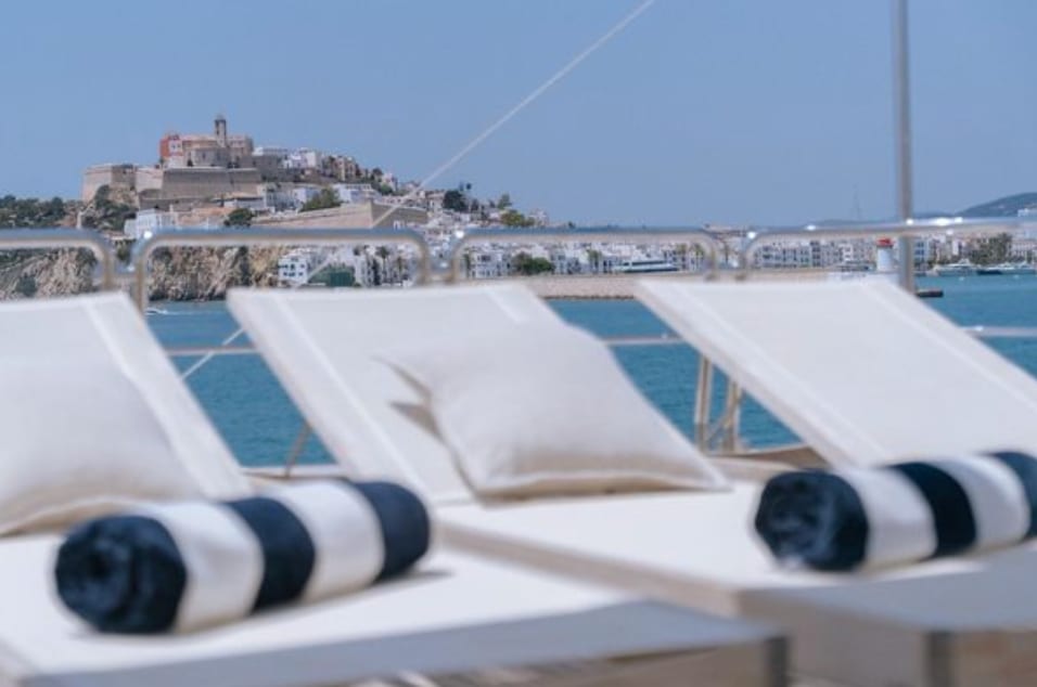 Sun deck loungers aboard M/Y Friendship, Ibiza town beyond